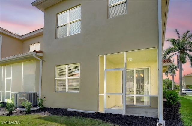 9820 Healthpark Cir Unit 101, Fort Myers, FL 33908 - rear view of house with stucco siding, central air condition unit, and a tile roof