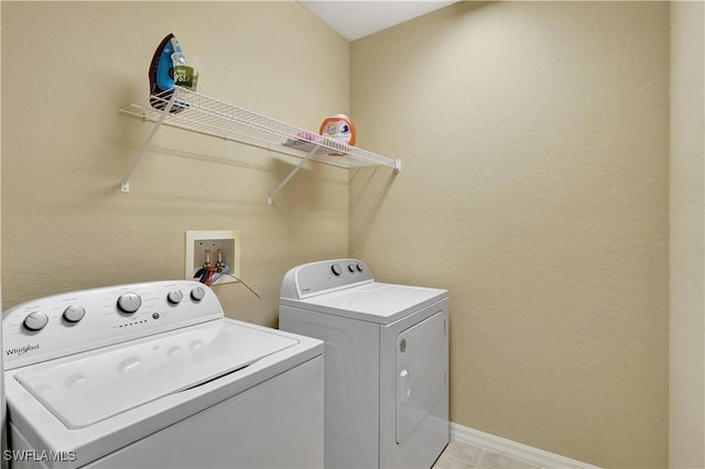 9820 Healthpark Cir Unit 101, Fort Myers, FL 33908 - laundry area with washing machine and dryer and baseboards