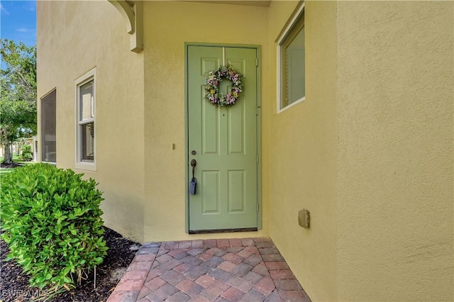9820 Healthpark Cir Unit 101, Fort Myers, FL 33908 - view of exterior entry featuring stucco siding