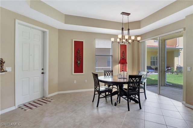 9820 Healthpark Cir Unit 101, Fort Myers, FL 33908 - dining room with a chandelier, baseboards, light tile patterned floors, and a raised ceiling