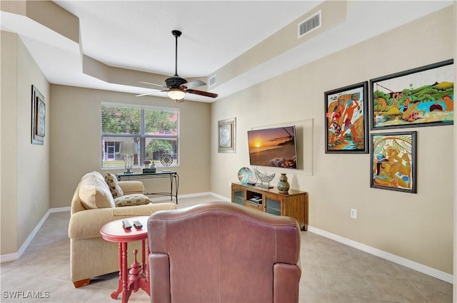 9820 Healthpark Cir Unit 101, Fort Myers, FL 33908 - living room featuring ceiling fan, light tile patterned floors, baseboards, and a tray ceiling
