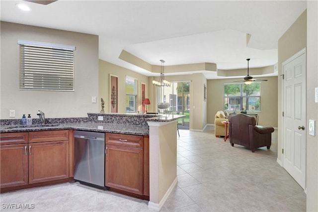 9820 Healthpark Cir Unit 101, Fort Myers, FL 33908 - kitchen with dishwasher, a raised ceiling, a sink, open floor plan, and dark stone countertops