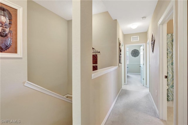 9820 Healthpark Cir Unit 101, Fort Myers, FL 33908 - hallway featuring an upstairs landing, baseboards, and carpet