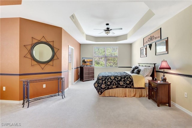 9820 Healthpark Cir Unit 101, Fort Myers, FL 33908 - bedroom with carpet floors, baseboards, a tray ceiling, and ceiling fan