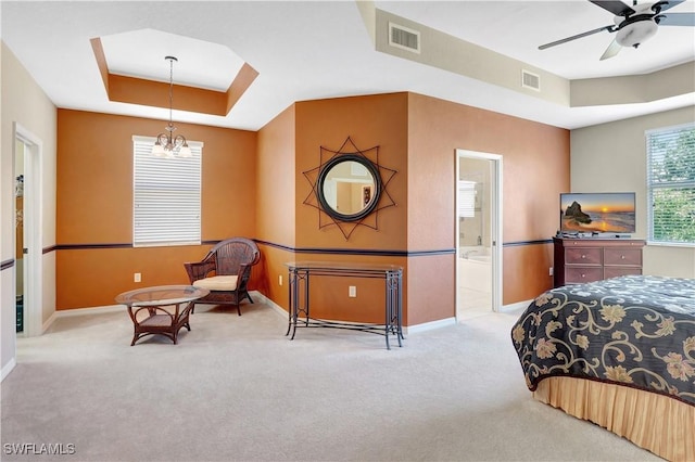 9820 Healthpark Cir Unit 101, Fort Myers, FL 33908 - bedroom with a tray ceiling, carpet floors, baseboards, a chandelier, and ensuite bath