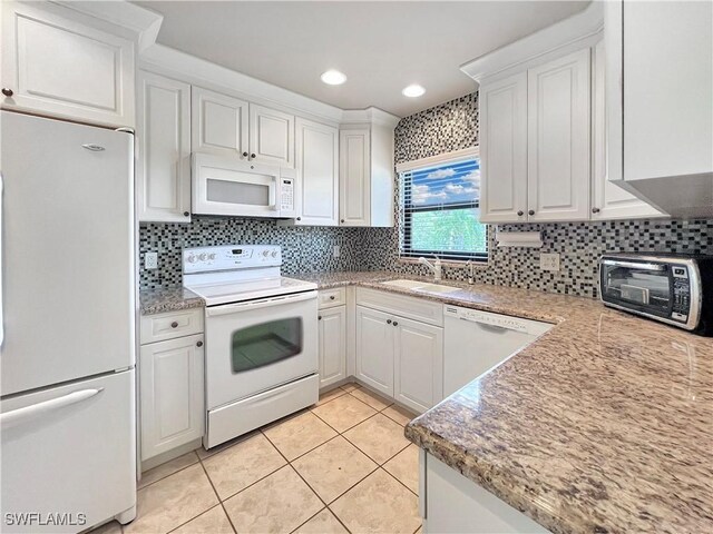 13264 White Marsh Ln Unit 3318, Fort Myers, FL 33912 - kitchen featuring white appliances, a sink, white cabinets, tasteful backsplash, and light tile patterned floors