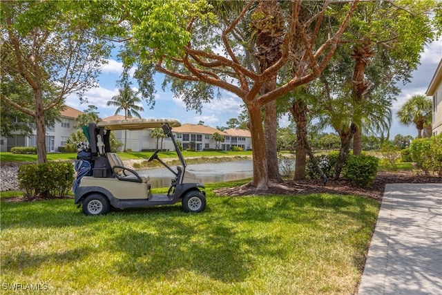 view of front of home featuring a front lawn, a water view, and a residential view