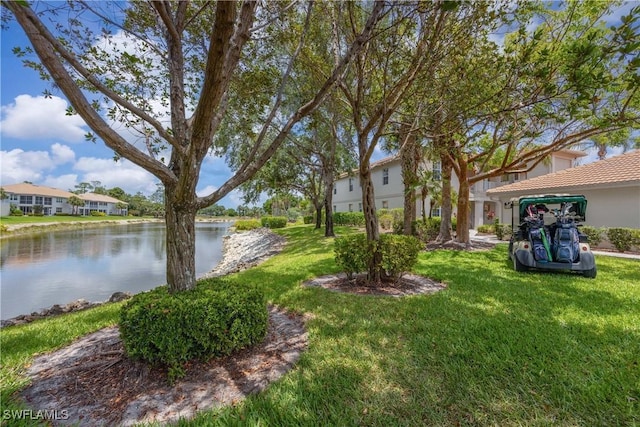 view of grassy yard with a water view