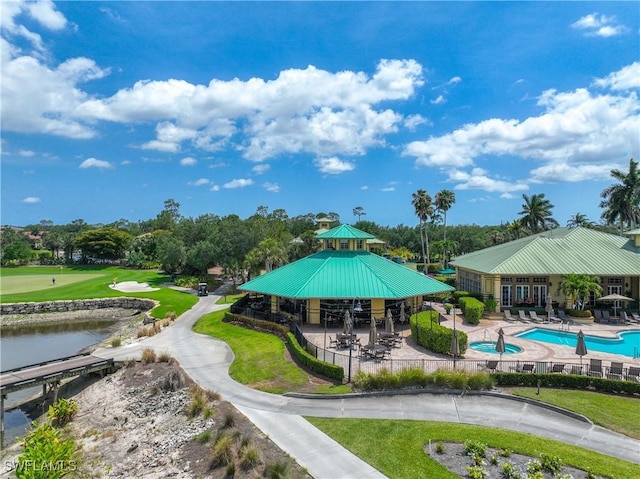 surrounding community with a gazebo, a pool, a water view, and view of scattered trees