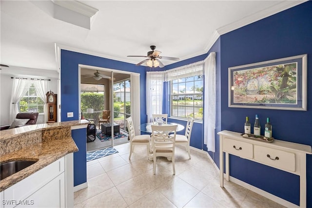 dining room featuring ornamental molding, light tile patterned floors, ceiling fan, and baseboards