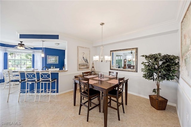 dining room with a chandelier, ornamental molding, and ceiling fan