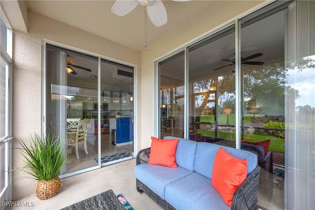 sunroom featuring a ceiling fan