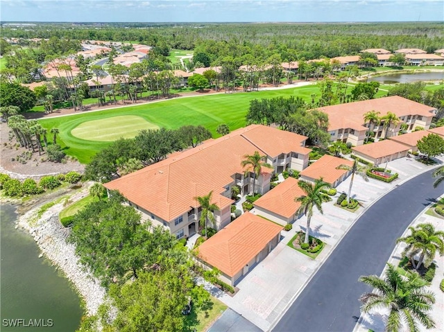 aerial view of residential area featuring a nearby body of water and a golf club