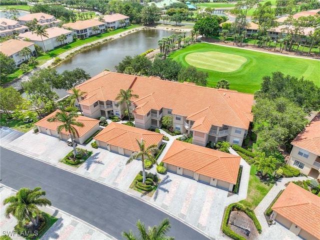 aerial view of residential area featuring a large body of water and a golf club