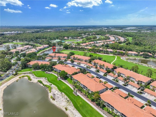 aerial view of property's location with a large body of water, a local golf course, and nearby suburban area