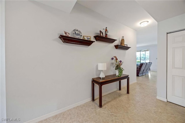 corridor featuring baseboards