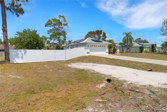 18298 Hepatica Rd, Fort Myers, FL 33967 - view of front of house featuring roof mounted solar panels, concrete driveway, and an attached garage