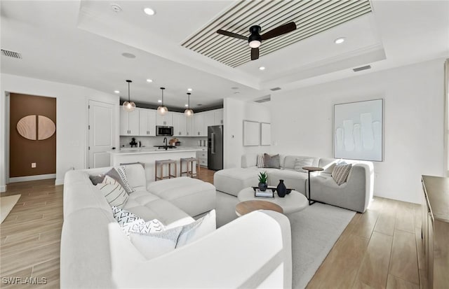 12429 Basalt Ln, Alva, FL 33982 - living area with a raised ceiling, recessed lighting, ceiling fan, light wood-type flooring, and baseboards