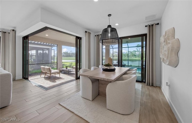 12429 Basalt Ln, Alva, FL 33982 - dining room with healthy amount of natural light, light wood-type flooring, baseboards, and recessed lighting