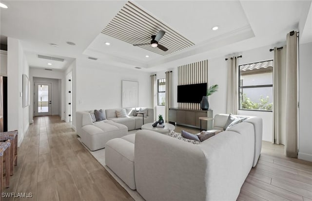 12429 Basalt Ln, Alva, FL 33982 - living area featuring a tray ceiling, ceiling fan, light wood-type flooring, recessed lighting, and baseboards