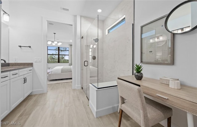 12429 Basalt Ln, Alva, FL 33982 - full bath with ensuite bath, a shower stall, vanity, baseboards, and a chandelier