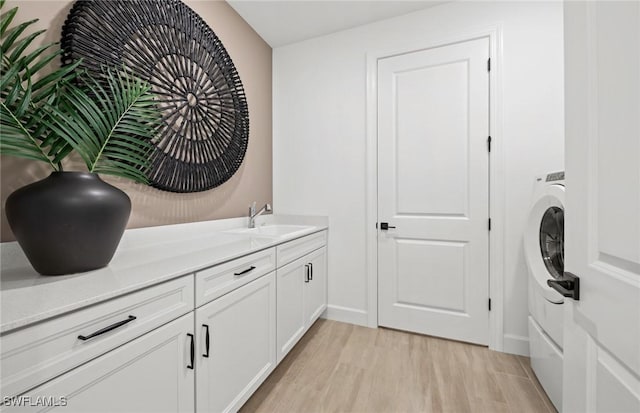 12429 Basalt Ln, Alva, FL 33982 - washroom featuring light wood-type flooring, cabinet space, and baseboards