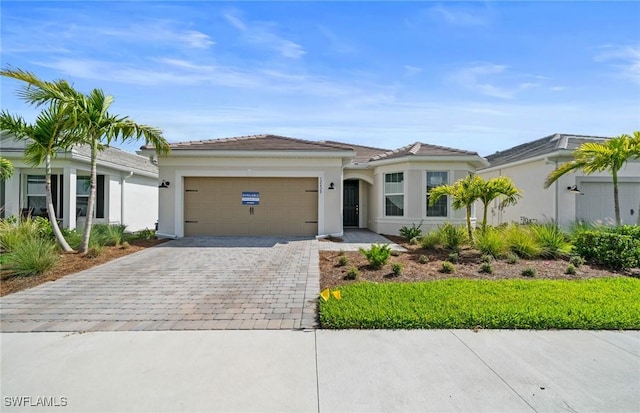12429 Basalt Ln, Alva, FL 33982 - single story home featuring decorative driveway, an attached garage, and stucco siding