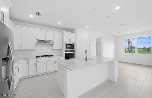 12429 Basalt Ln, Alva, FL 33982 - kitchen with appliances with stainless steel finishes, under cabinet range hood, decorative backsplash, white cabinetry, and recessed lighting