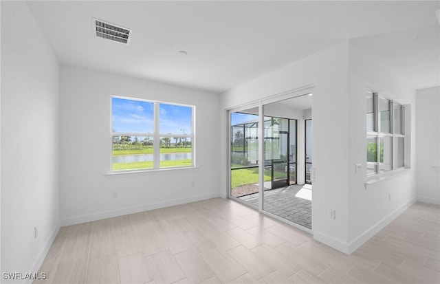12429 Basalt Ln, Alva, FL 33982 - empty room with baseboards and a water view
