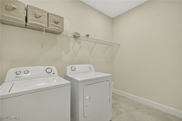 17672 Silverspur Dr, Punta Gorda, FL 33982 - laundry room with washing machine and clothes dryer and light tile patterned flooring