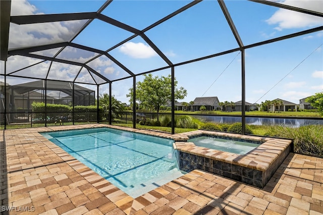 17672 Silverspur Dr, Punta Gorda, FL 33982 - view of pool featuring a water view, a patio area, a pool with connected hot tub, and glass enclosure
