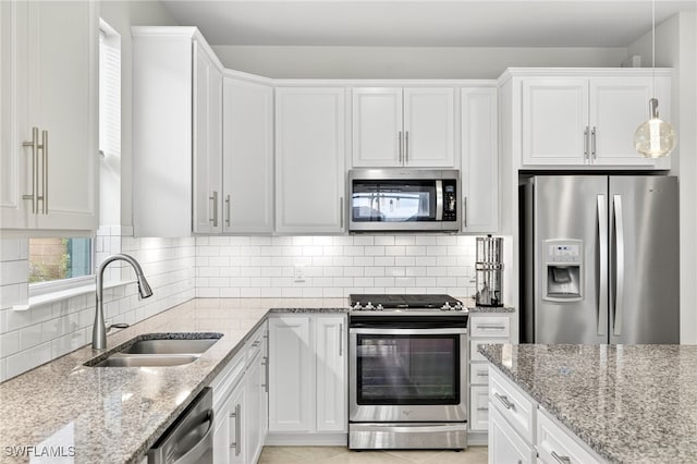 17672 Silverspur Dr, Punta Gorda, FL 33982 - kitchen with appliances with stainless steel finishes, light stone countertops, and white cabinets