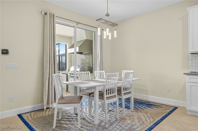 17672 Silverspur Dr, Punta Gorda, FL 33982 - dining area with light tile patterned floors and baseboards
