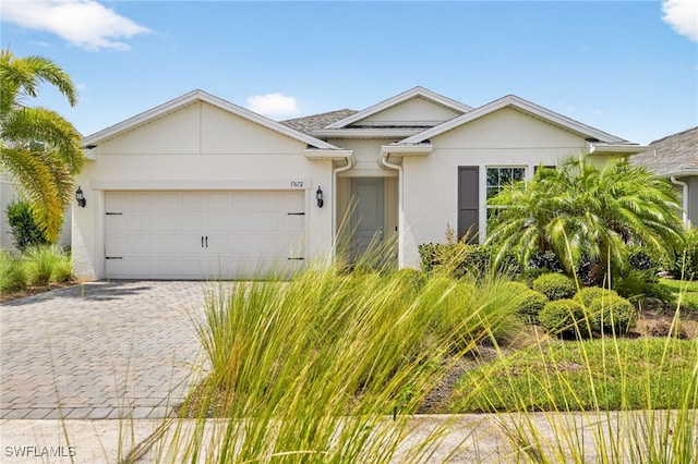 17672 Silverspur Dr, Punta Gorda, FL 33982 - ranch-style house featuring a garage, stucco siding, and decorative driveway