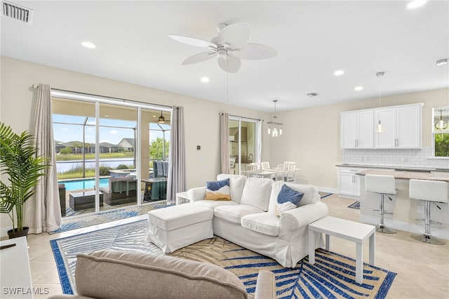 17672 Silverspur Dr, Punta Gorda, FL 33982 - living area featuring light tile patterned floors, ceiling fan, recessed lighting, and a water view