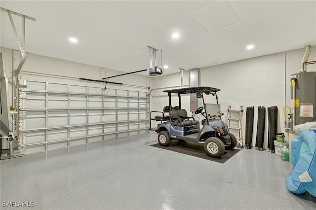17672 Silverspur Dr, Punta Gorda, FL 33982 - garage with water heater, a garage door opener, concrete block wall, and recessed lighting