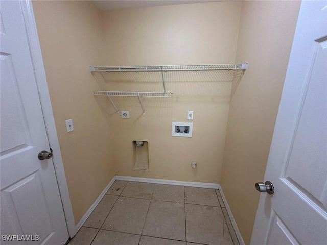 clothes washing area with hookup for an electric dryer, baseboards, washer hookup, and light tile patterned flooring