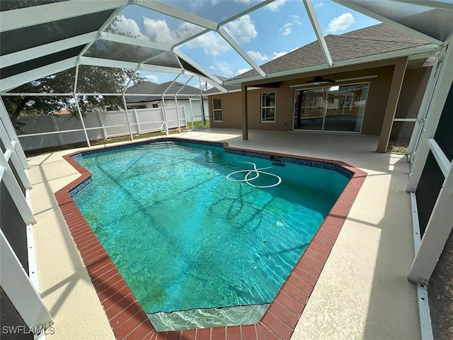 view of pool with a patio area, a ceiling fan, fence, and a lanai