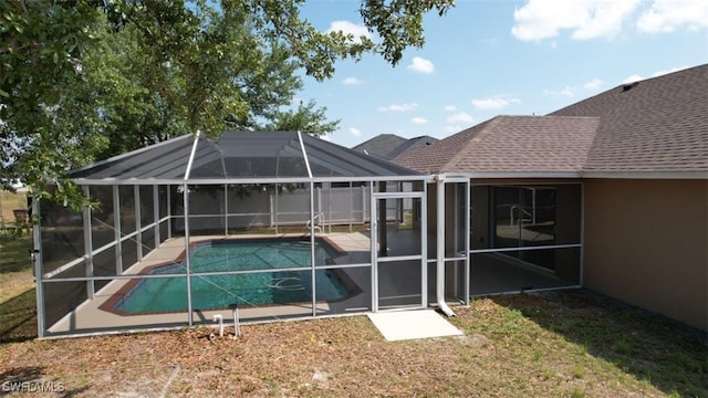 outdoor pool featuring a patio area and a lanai
