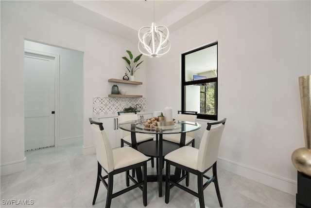 24131 Cock Robin Ln, Bonita Springs, FL 34135 - dining room featuring baseboards, a chandelier, and light marble finish floors