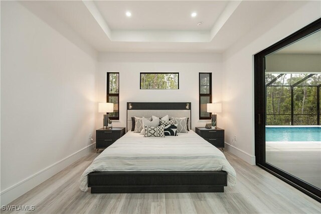 24131 Cock Robin Ln, Bonita Springs, FL 34135 - bedroom with a raised ceiling, multiple windows, light wood-type flooring, baseboards, and recessed lighting