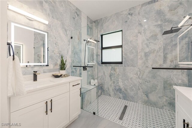 24131 Cock Robin Ln, Bonita Springs, FL 34135 - full bath featuring vanity, a marble finish shower, and tile walls