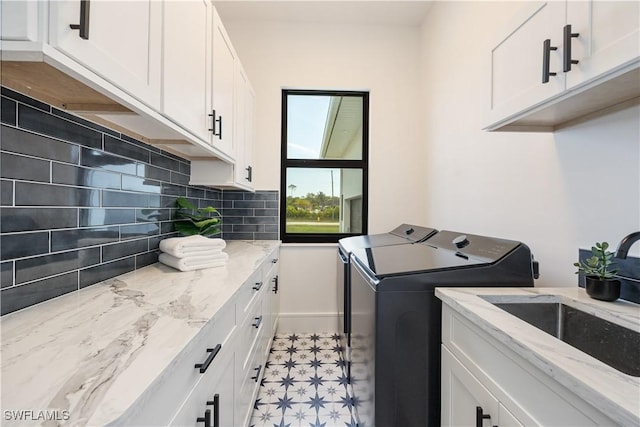 24131 Cock Robin Ln, Bonita Springs, FL 34135 - washroom featuring washing machine and clothes dryer, light flooring, and cabinet space