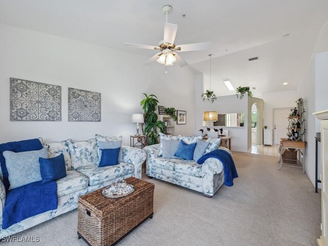 carpeted living room with ceiling fan, arched walkways, lofted ceiling, and recessed lighting