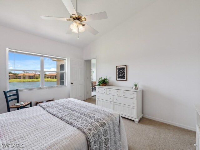 bedroom featuring a water view, light colored carpet, baseboards, ceiling fan, and vaulted ceiling