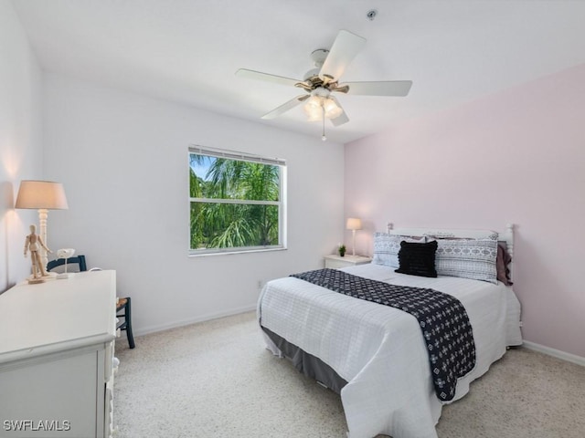 bedroom with baseboards, a ceiling fan, and light colored carpet
