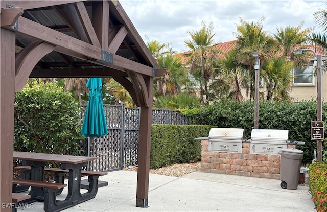 view of patio featuring area for grilling, an outdoor kitchen, a gazebo, and fence