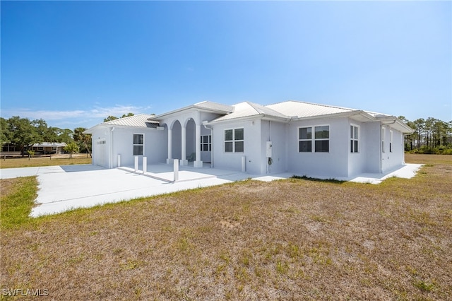 1083 Pollywog Dr, Labelle, FL 33935 - back of house with a patio, stucco siding, and metal roof