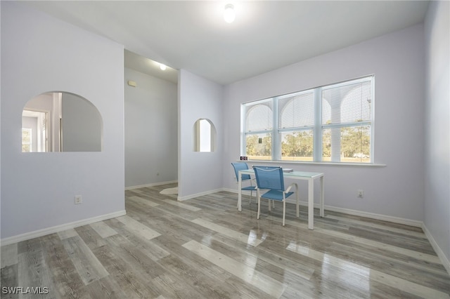 1083 Pollywog Dr, Labelle, FL 33935 - office area featuring wood finished floors, baseboards, and arched walkways