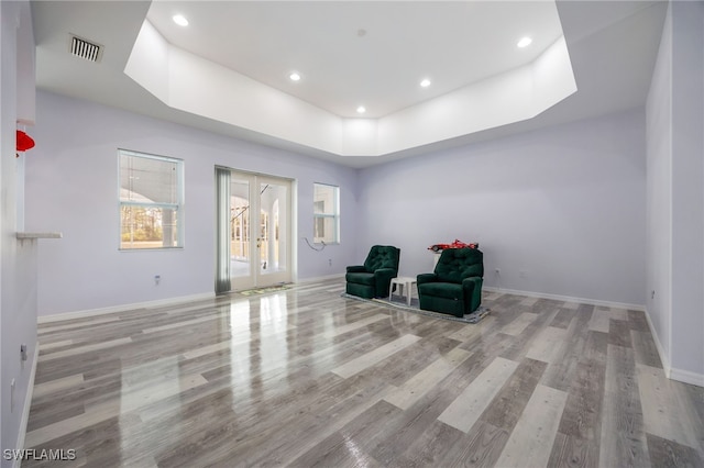 1083 Pollywog Dr, Labelle, FL 33935 - living area with wood finished floors, a tray ceiling, baseboards, french doors, and recessed lighting
